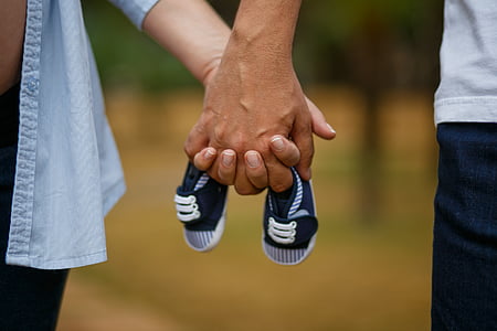 selective focus photography of persons holding hands