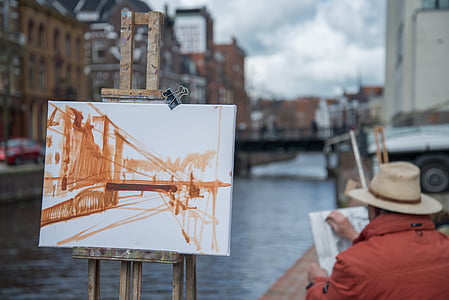 man painting a suspension bridge