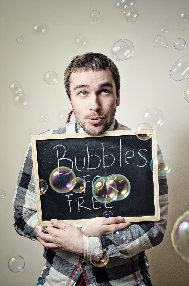 man showing Bubbles for free signboard