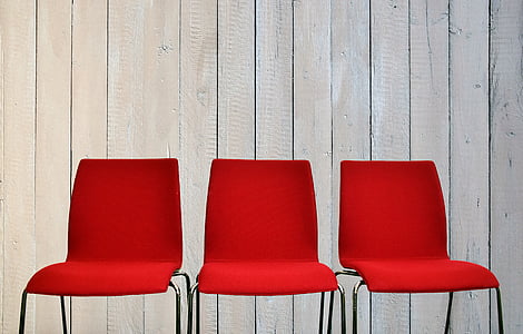 three red-and-gray metal chairs
