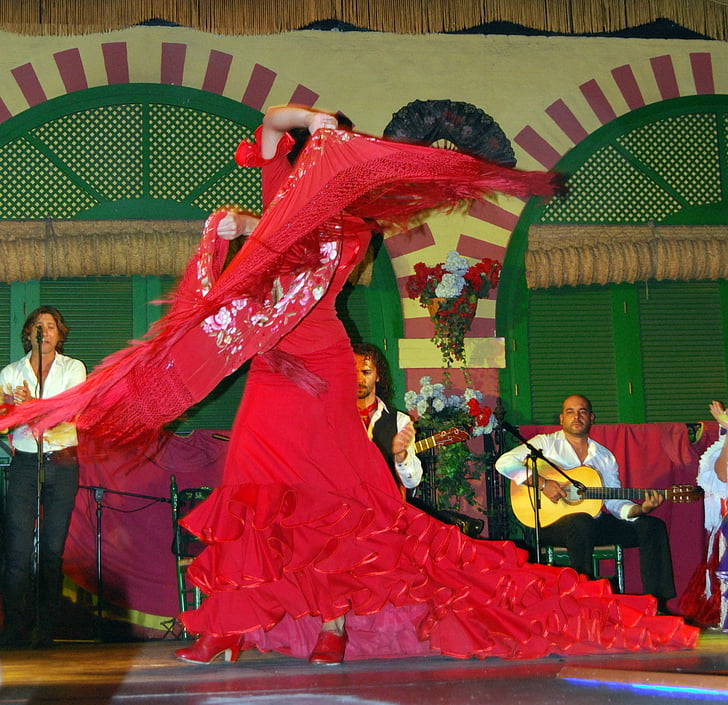 woman wearing red flare dress while dancing