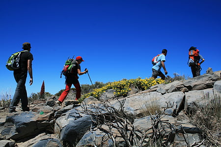 five man hiking on gray mountain
