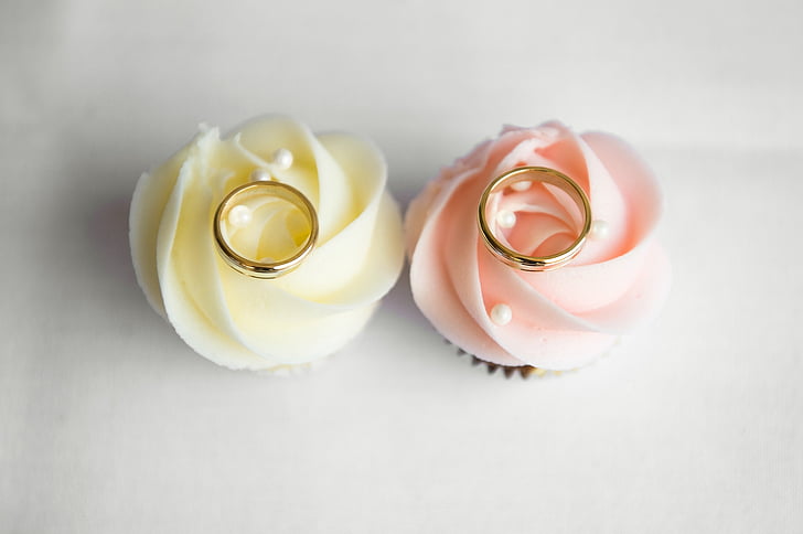 two gold-colored rings on flower decors