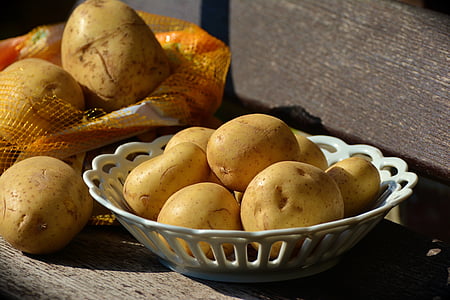 brown potatoes in white plastic basket