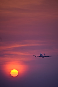 white airplane flying during sunset