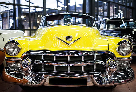 selective focus photography of a classic yellow car