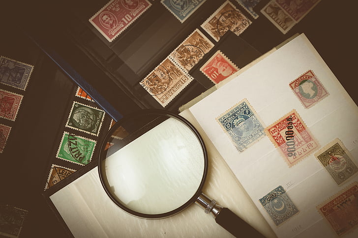 Philatelist Looks At Postage Stamps Stock Photo - Download Image Now - Stamp  Collecting, Postage Stamp, Collection - iStock