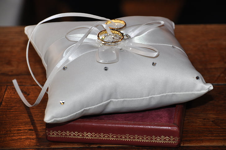 gold-colored rings on gray cushions