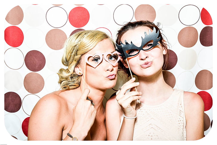 two women holding eye masks