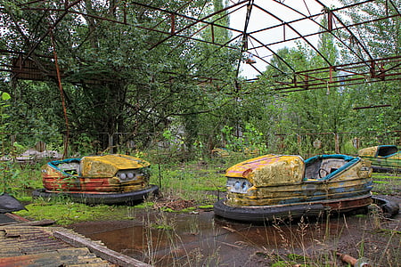 two yellow abandoned bumper cars at daytime