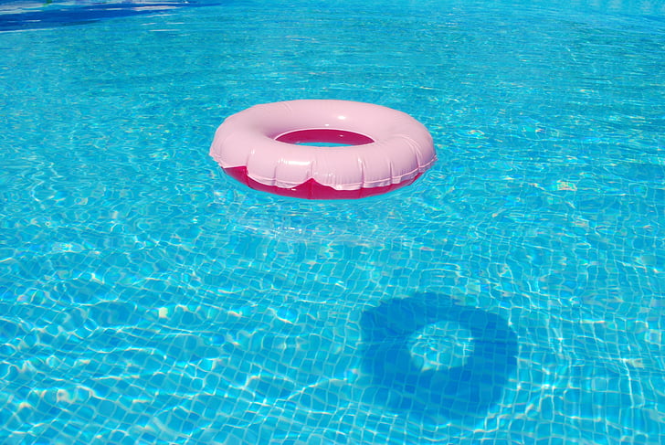 white and red buoy on blue swimming pool
