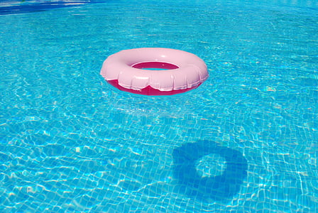 white and red buoy on blue swimming pool