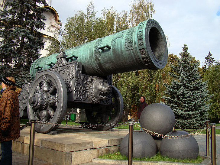 teal and gray metal cannon monument during daytime