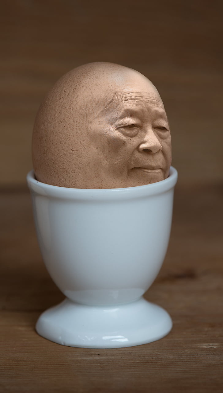 egg with face in white cup
