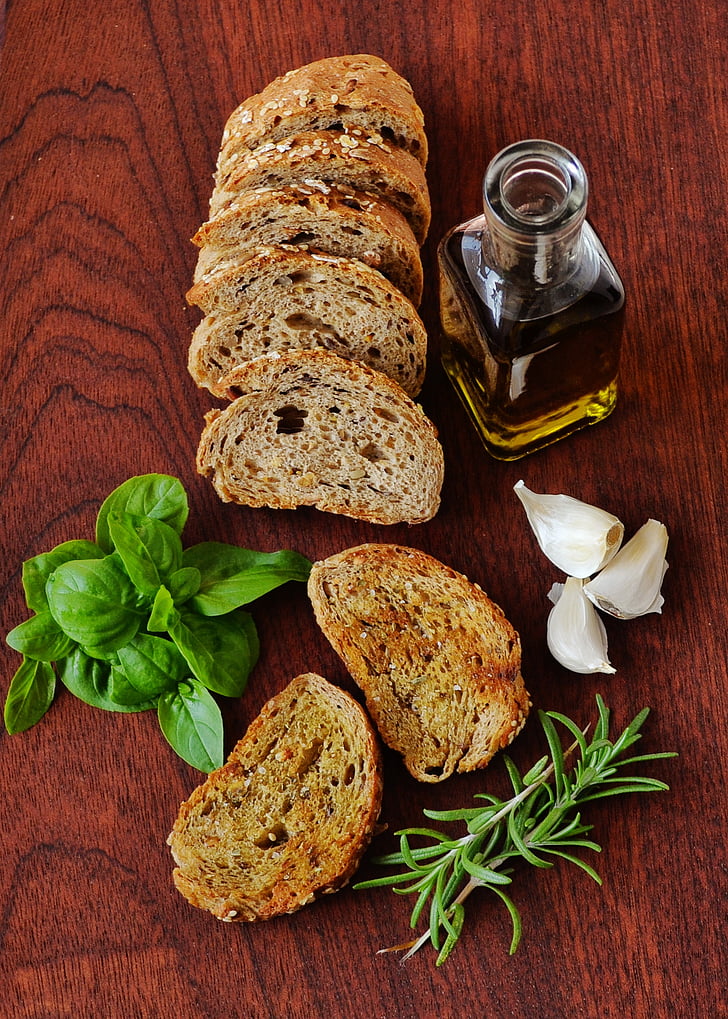 sliced wheat bread with oil and garlic clove