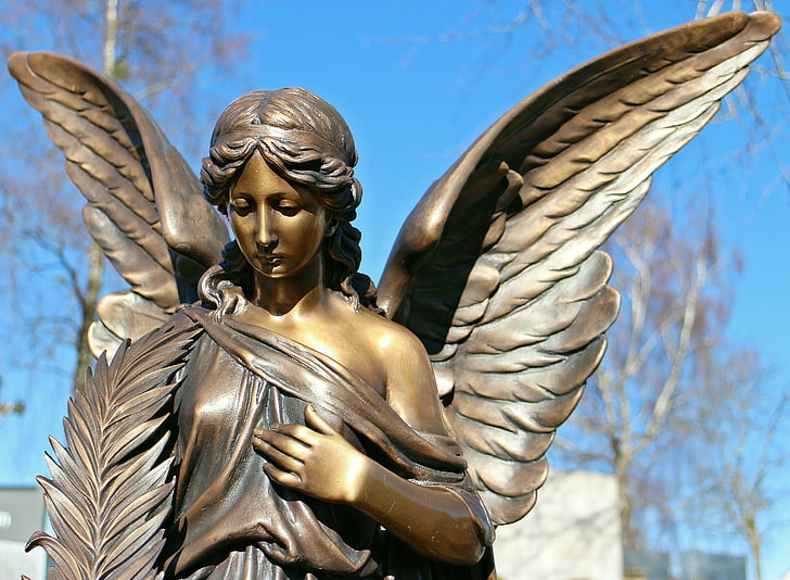 brown steel angel figurine during daytime