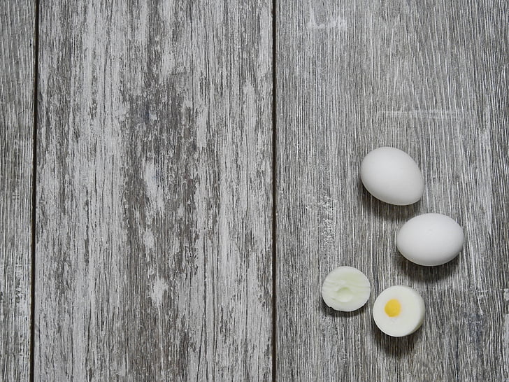 hard-boiled egg on gray wooden surface