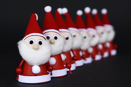 line of Santa Claus articulating dolls selective focus photography