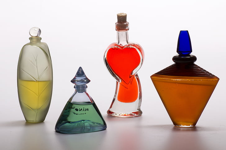 four assorted glass fragrance bottles