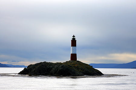 photography of lighthouse center of body of water
