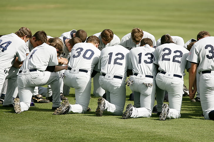 baseball players gathered on field
