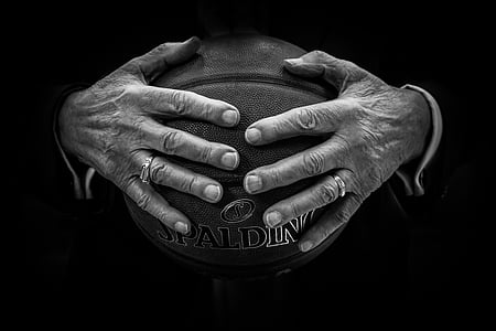 person holding brown Spalding basketball ball