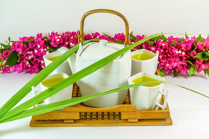 white ceramic 5-piece tea set placed on beige wooden tray
