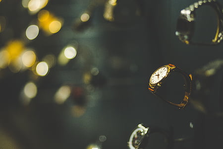 selective focus photography of gold-colored analog watch