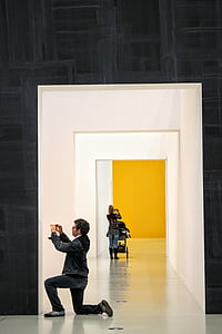 man taking picture in front the white door