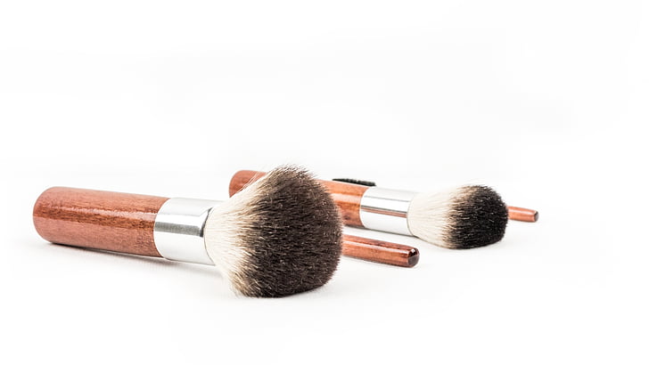two brown-and-white makeup brush