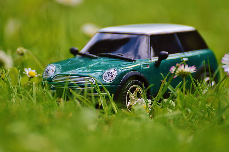 closeup photo of green Mini Cooper scale model on green grass
