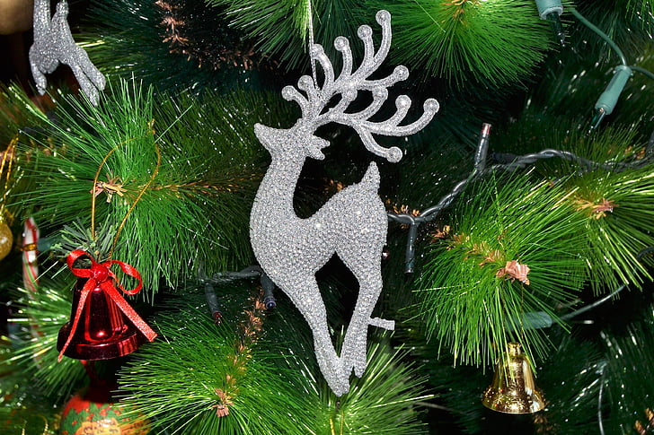 closeup of Christmas tree with bells and deer ornaments