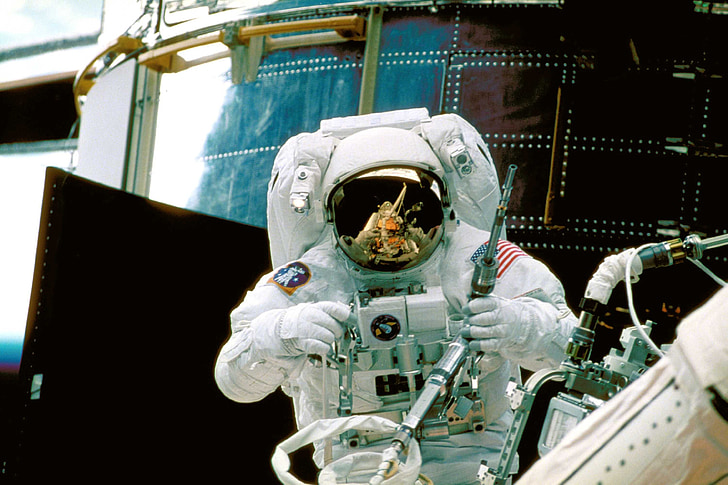 astronaut holding equipment