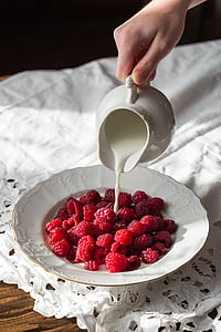 raspberries on white ceramic plate