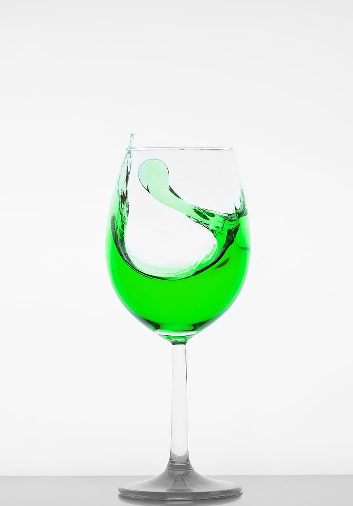 clear wine glass filled with green liquid