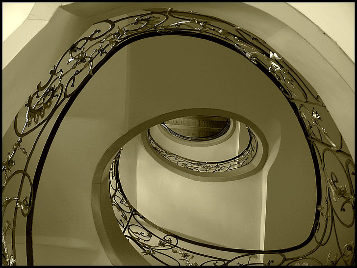 high-angle photography of spiral staircase with railings