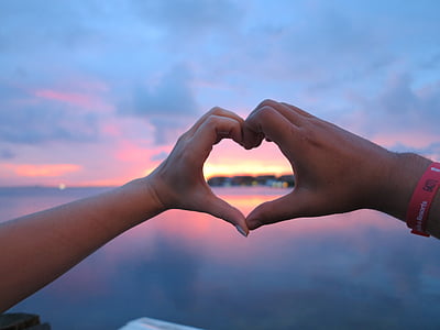 two person making heart hand sign