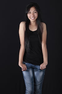 woman wearing black tank top and blue jeans