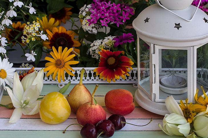 assorted fruits near candle lantern