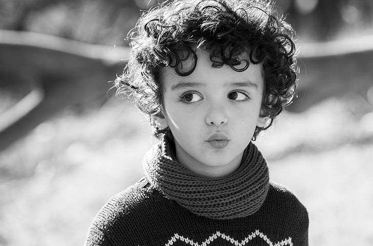 child wearing turtleneck sweater looking right