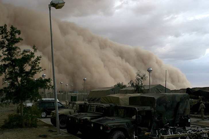 large brown smoke on military camp during dayime