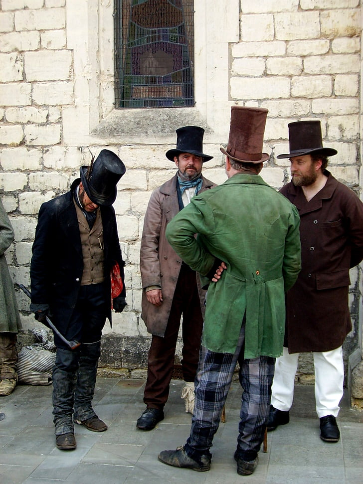 four men wearing coats
