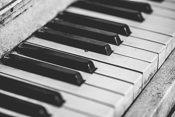 grayscale photography of upright piano