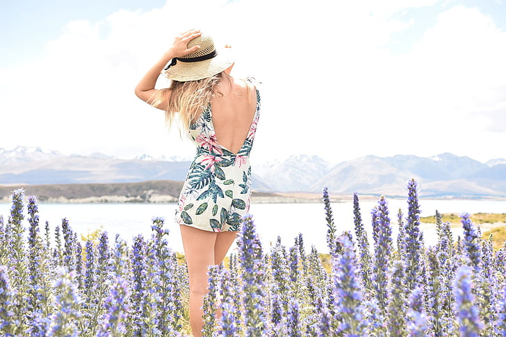 woman wearing floral backless dress surrounded by lavender flowers