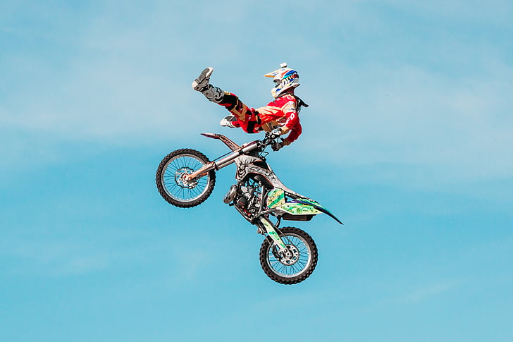 man doing air stunt on motocross dirt bike