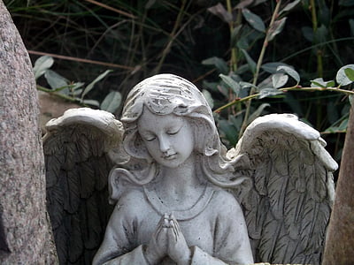 gray concrete angel statue near tree
