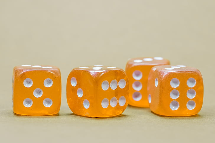 four orange-and-white dices