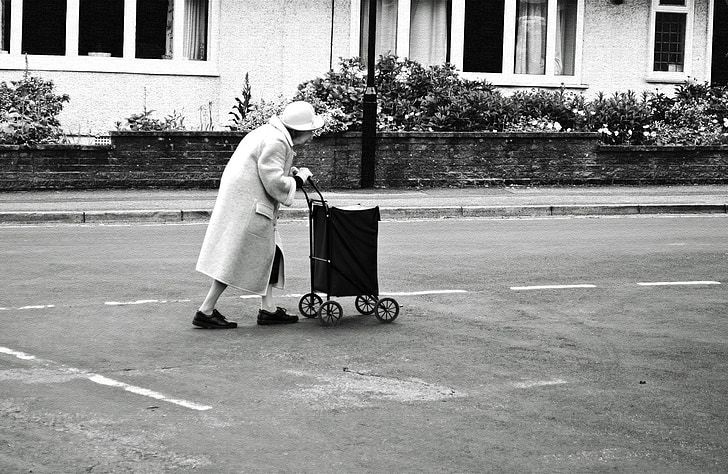 woman holding cart on road