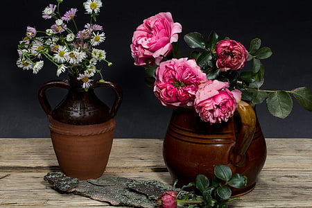 pink roses in brown vase on table