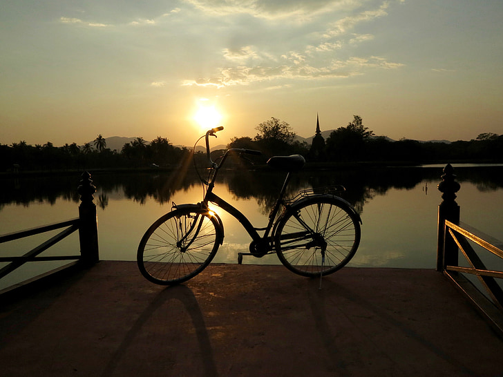 black cruiser bike on dock during golden hour